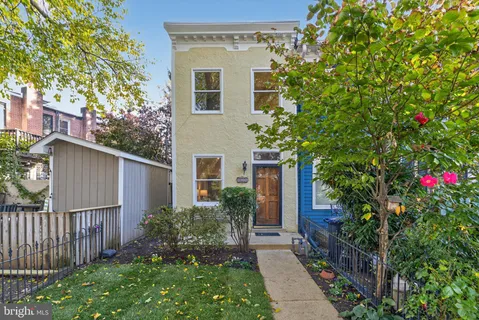a house that has a tree in front of it