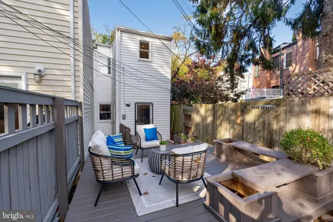 a view of a backyard with sitting area
