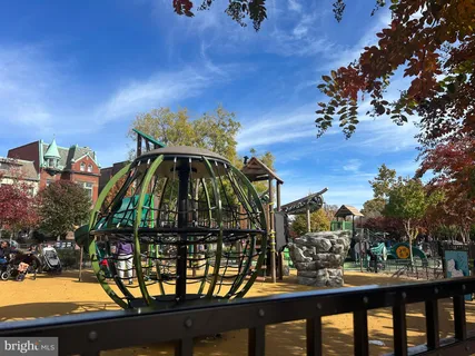 a street sign on a wall next to road