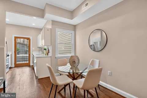 a dining room with furniture and a window