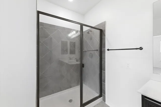 a bathroom with a glass shower door