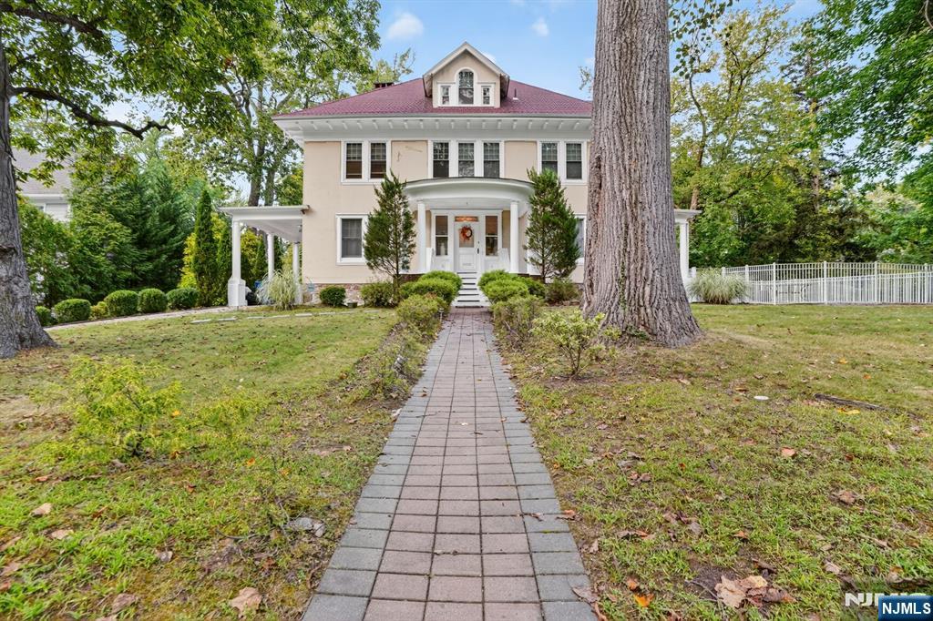 a front view of a house with a garden