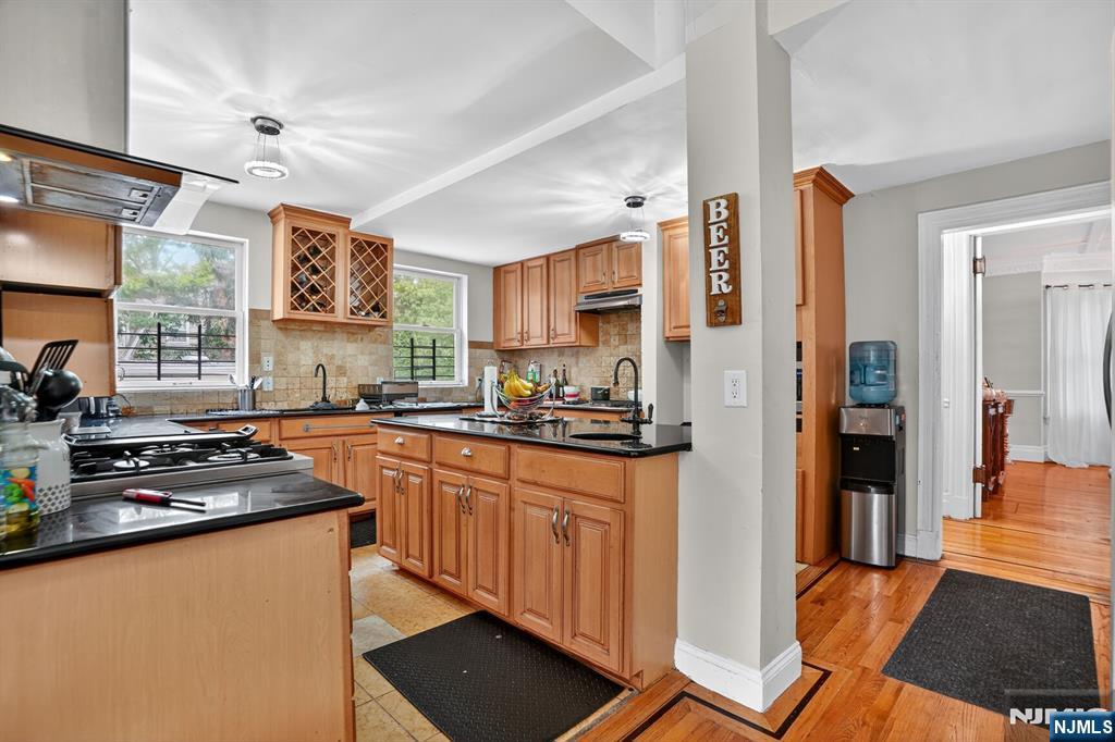 285 Maple Street Englewood, NJ 07631 - Photo 11 of 29 a kitchen with stainless steel appliances granite countertop a refrigerator and a stove top oven