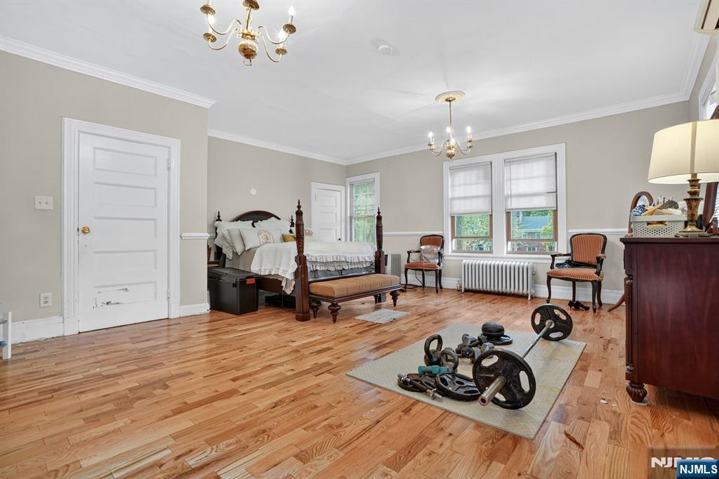 285 Maple Street Englewood, NJ 07631 - Photo 15 of 29 a bed room with furniture window and wooden floor