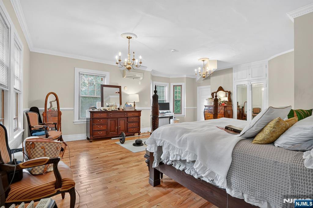 285 Maple Street Englewood, NJ 07631 - Photo 17 of 29 a bedroom with a bed and wooden floor