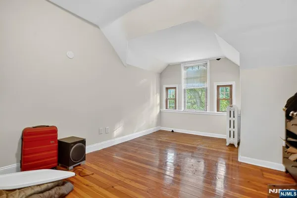 a view of room with window and wooden floor
