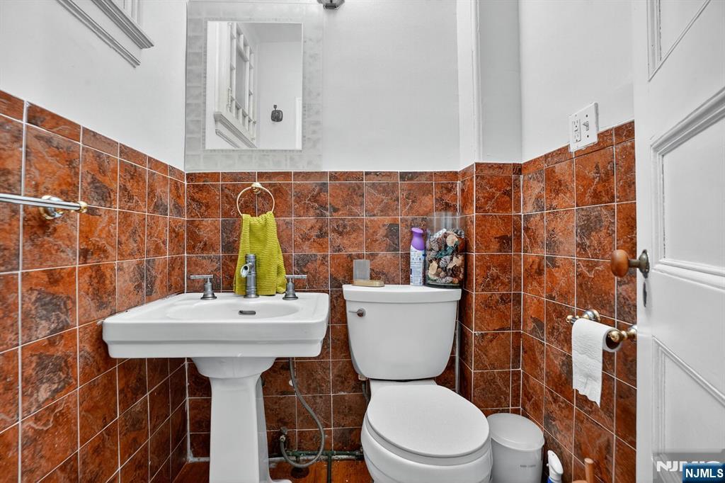 285 Maple Street Englewood, NJ 07631 - Photo 21 of 29 a bathroom with a sink mirror toilet and shower