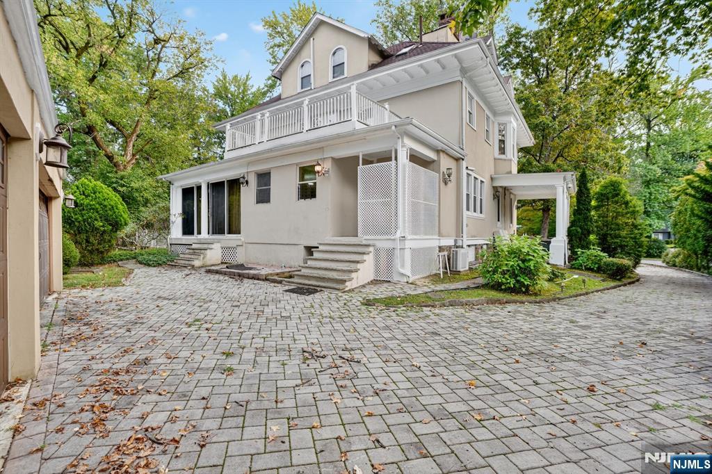 285 Maple Street Englewood, NJ 07631 - Photo 26 of 29 a white house that has a tree in front of it