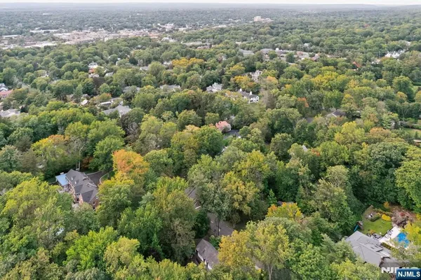an aerial view of a houses with a yard