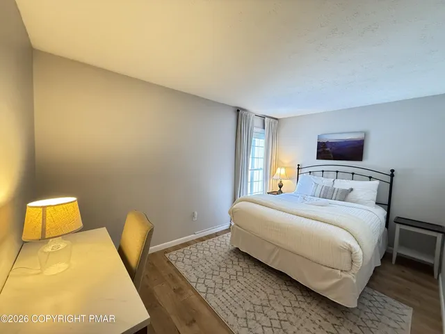 a view of a livingroom with wooden floor and stairs