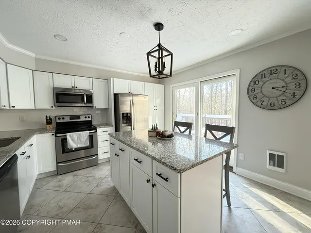 a living room with furniture large window and a fireplace
