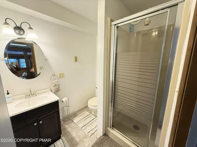 a view of a patio with chairs and large trees