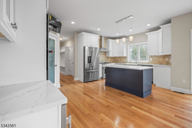 118 Cambridge Road Westfield, NJ 07090 - Photo 12 of 50 a open kitchen with stainless steel appliances kitchen island granite countertop a refrigerator and a sink