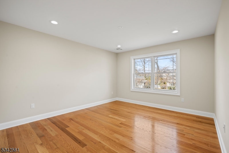118 Cambridge Road Westfield, NJ 07090 - Photo 26 of 50 a view of an empty room with wooden floor and a window