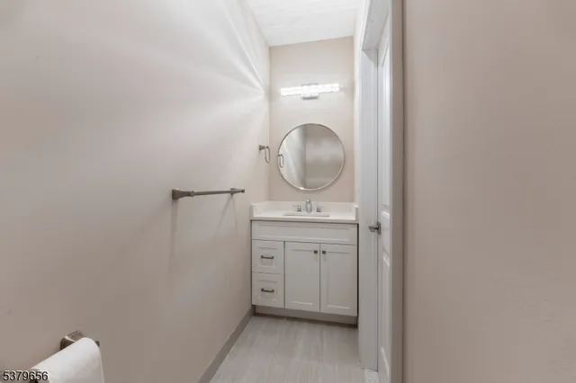 a bathroom with a granite countertop toilet sink and a mirror