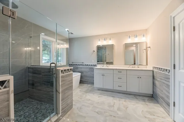 a en suite bathroom with a double sink shower and a mirror