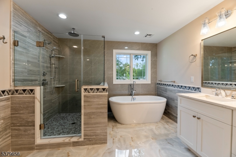 118 Cambridge Road Westfield, NJ 07090 - Photo 41 of 50 a en suite bathroom with a double sink shower and a mirror