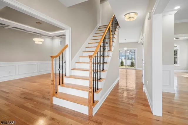 a view of entryway and hall with wooden floor