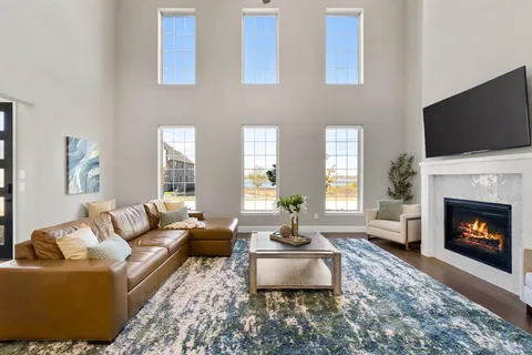 a living room with furniture a flat screen tv and a fireplace