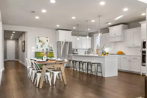 a dining room with furniture and a wooden floor