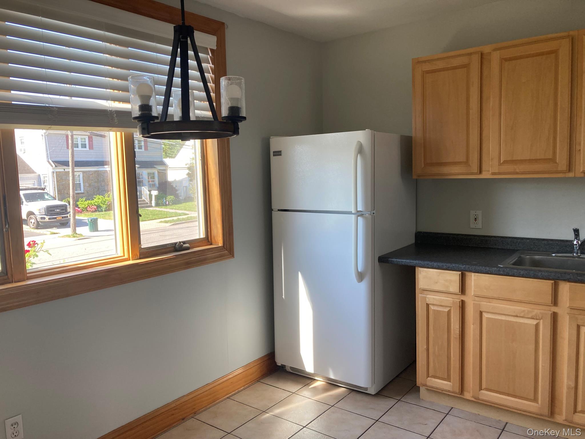 513 Marcellus Road, Unit 1 Williston Park, NY 11596 - Photo 5 of 11 a white refrigerator freezer and a stove sitting inside of a kitchen