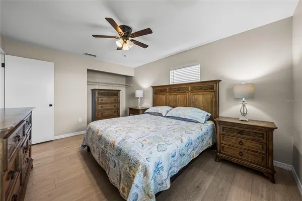 a bedroom with a bed and ceiling fan