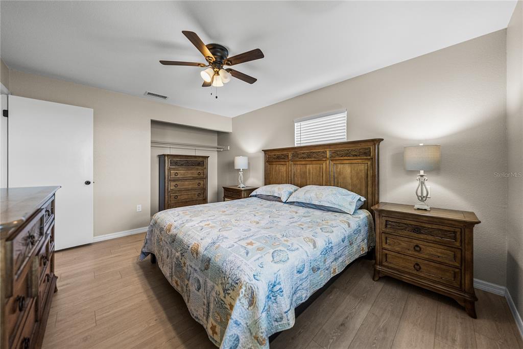 104 North Lake Reedy Boulevard Frostproof, FL 33843 - Photo 15 of 50 a bedroom with a bed and ceiling fan