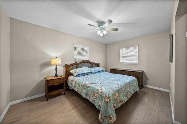 a bedroom with a bed chandelier and a window