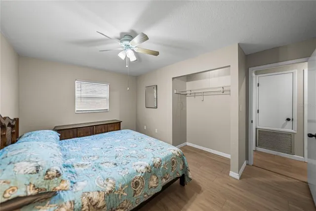 a bedroom with a large bed and a window