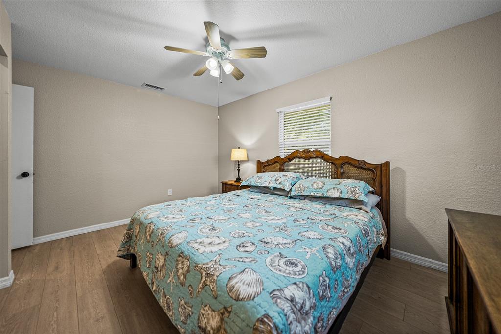104 North Lake Reedy Boulevard Frostproof, FL 33843 - Photo 20 of 50 a bedroom with a bed and a chandelier
