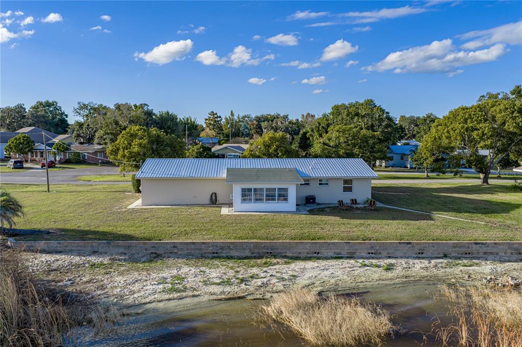 104 North Lake Reedy Boulevard Frostproof, FL 33843 - Photo 29 of 50 a front view of a house with a yard