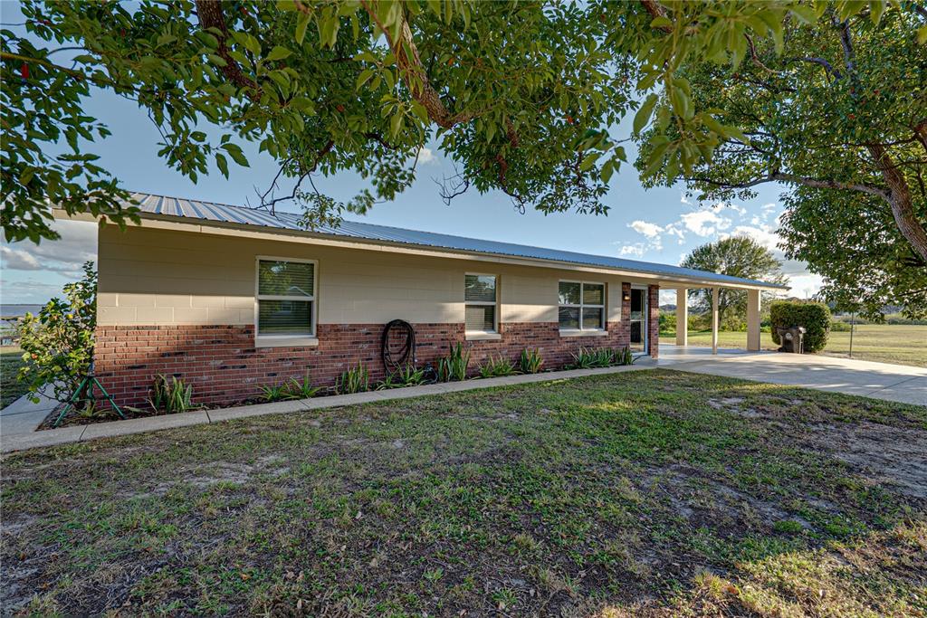 104 North Lake Reedy Boulevard Frostproof, FL 33843 - Photo 35 of 50 a front view of a house with garden