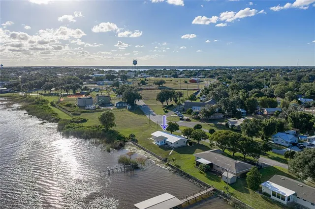 an aerial view of a city with lots of residential buildings and mountain view in back