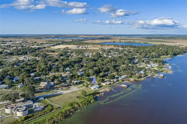 an aerial view of ocean and residential houses