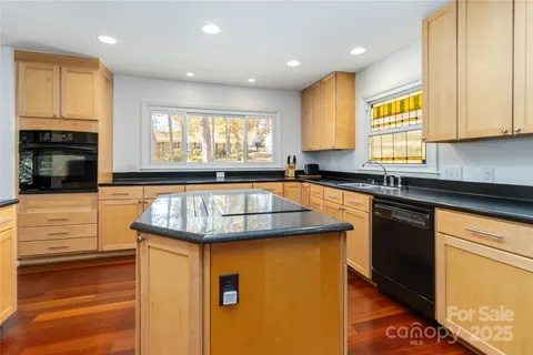 a kitchen with granite countertop sink stove and cabinets