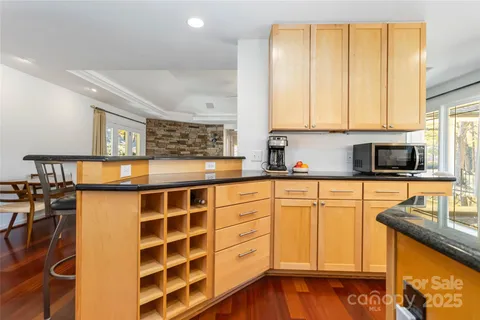 a kitchen with stainless steel appliances granite countertop a sink and cabinets