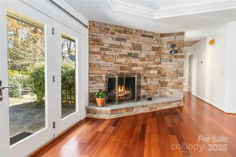 a living room with a fireplace and next to a window