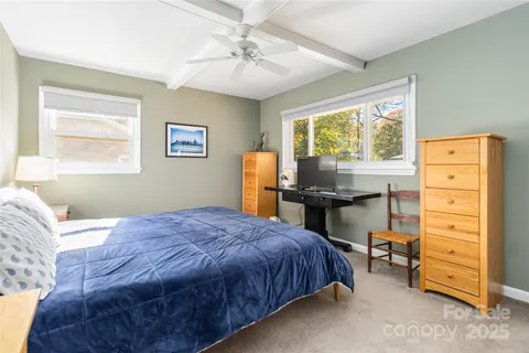 a bed room with a bed and a window