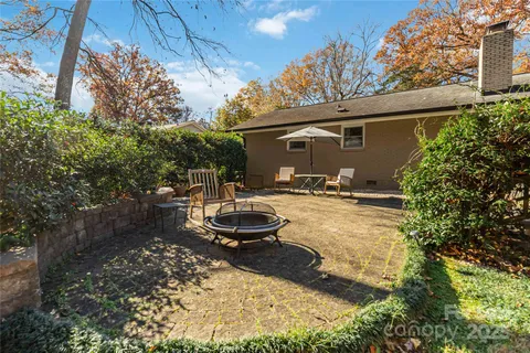 a backyard of a house with yard and outdoor seating