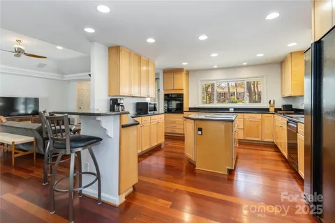 a kitchen with stainless steel appliances granite countertop a stove top oven a sink a counter top space and cabinets