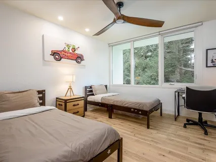 a bedroom with a bed and wooden floor