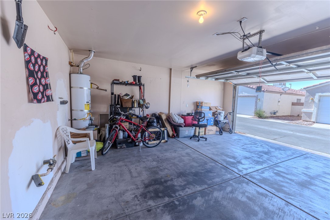 4994 Mascaro Drive Las Vegas, NV 89122 - Photo 27 of 30 A spacious garage, complete with a functional garage door opener, offers ample storage and utility.