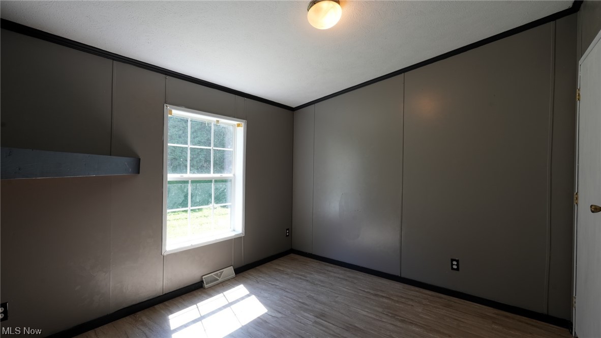 70871 Angus Road Cambridge, OH 43725 - Photo 27 of 29 Empty room with light hardwood flooring