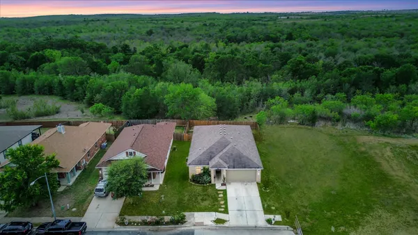 an aerial view of a house with a yard
