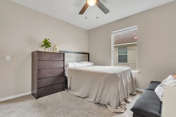 a bedroom with a bed and a window