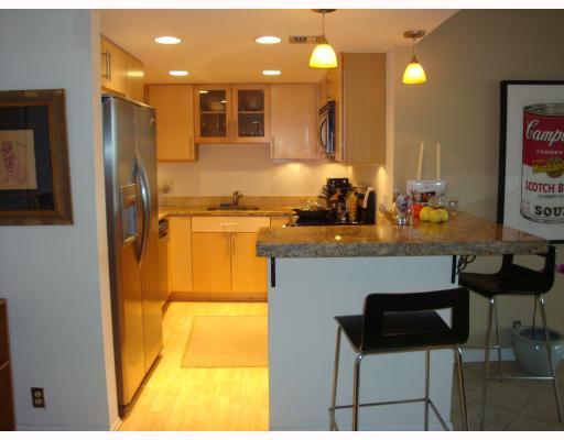 336 Golfview Road, Unit 1008 North Palm Beach, FL 33408 - Photo 4 of 5 a kitchen with a sink cabinets and dining table