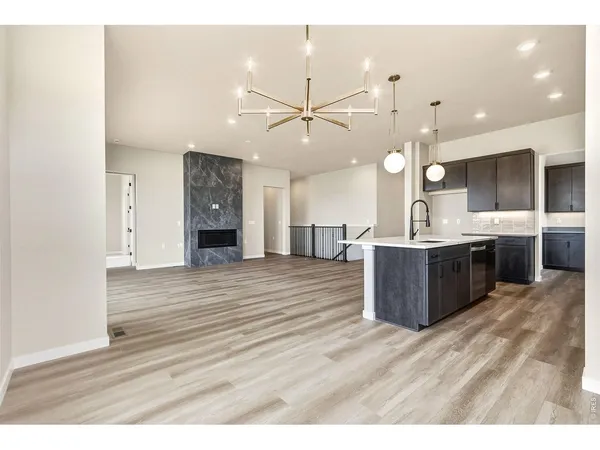 a kitchen with kitchen island a counter space a sink appliances and cabinets