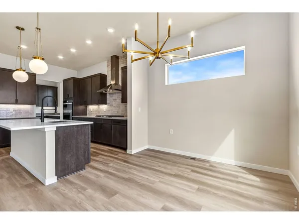 a kitchen with stainless steel appliances kitchen island a cabinets and wooden floor