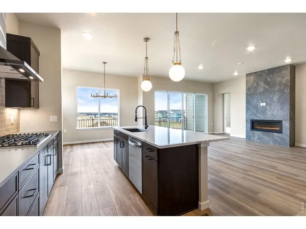 a kitchen with stainless steel appliances granite countertop a stove and a wooden floors