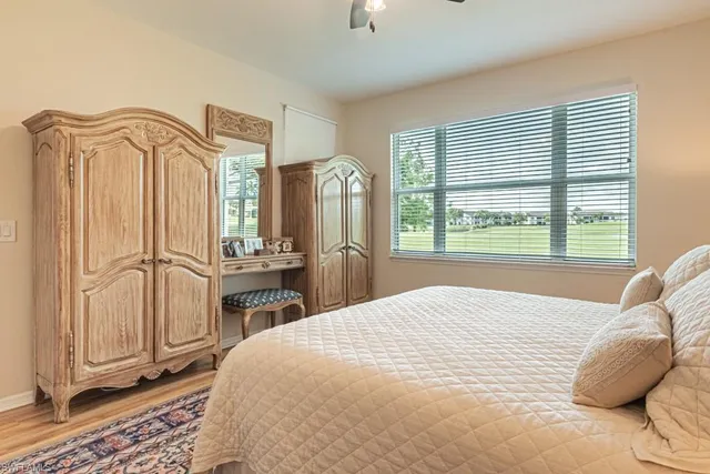 a bedroom with a bed dresser and a window